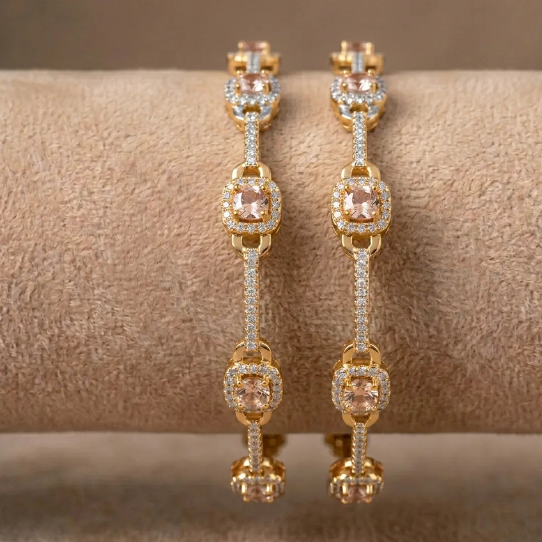 Luxury gold-toned bangle with earthy bronze stones and intricate petal motifs.