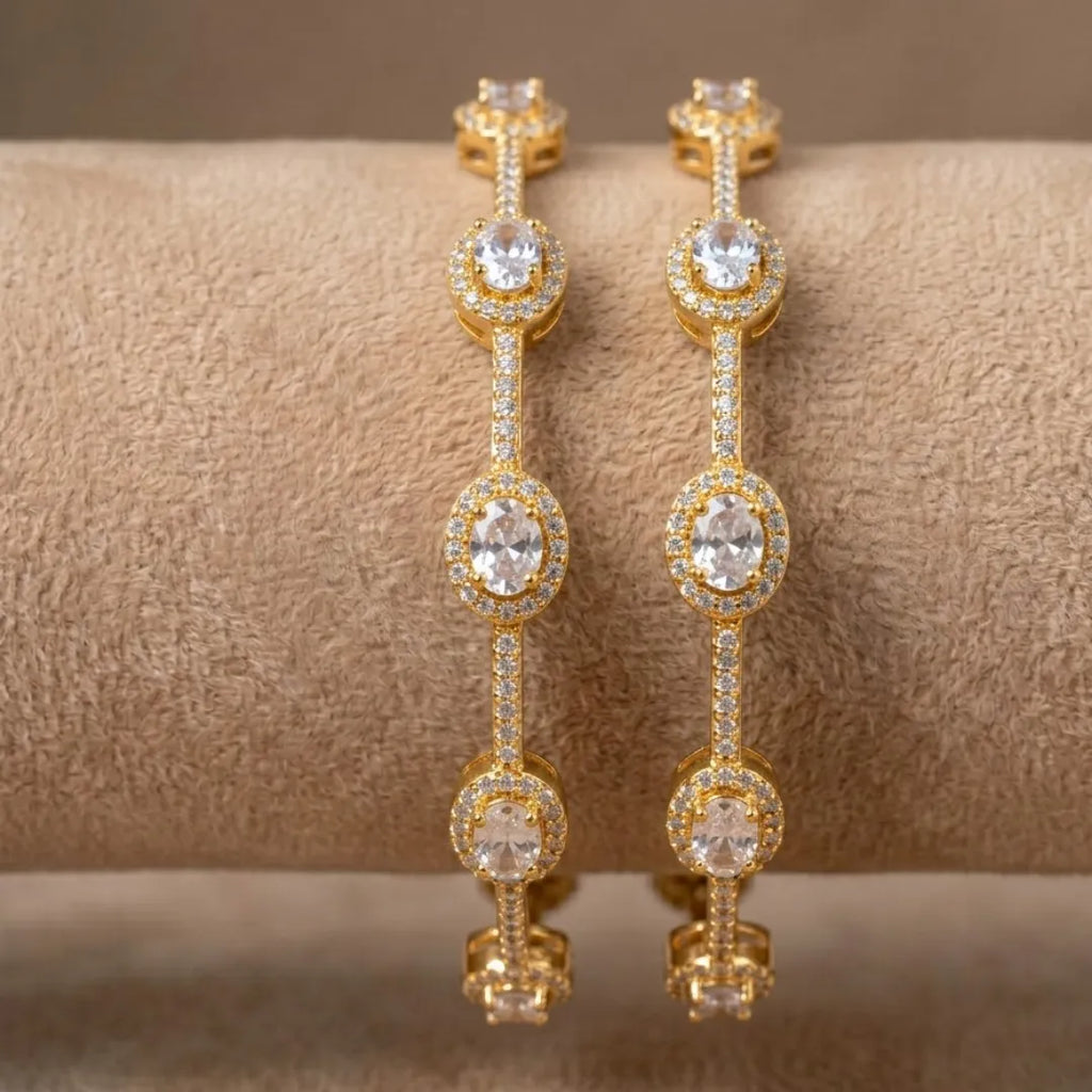 Luxury silver-plated eternity bangle with baguette-cut zirconia stones on a professional display.