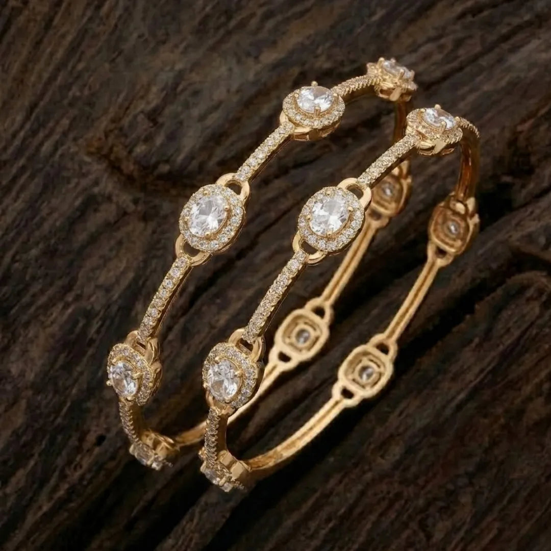 Luxury silver-plated eternity bangle with baguette-cut zirconia stones on a professional display.