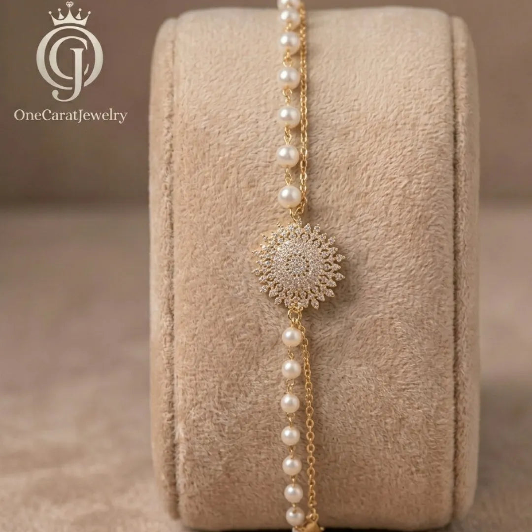 Woman wearing a delicate sunburst pearl bracelet with a white blazer for a luxury look.