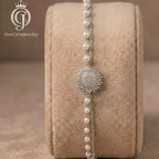 Silver-plated sunburst and pearl bracelet displayed on a velvet jewelry roll.