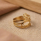 Gold ring with 'Smile' engraving on a beige fabric background