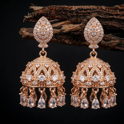 Pair of gold and diamond earrings on a dark background