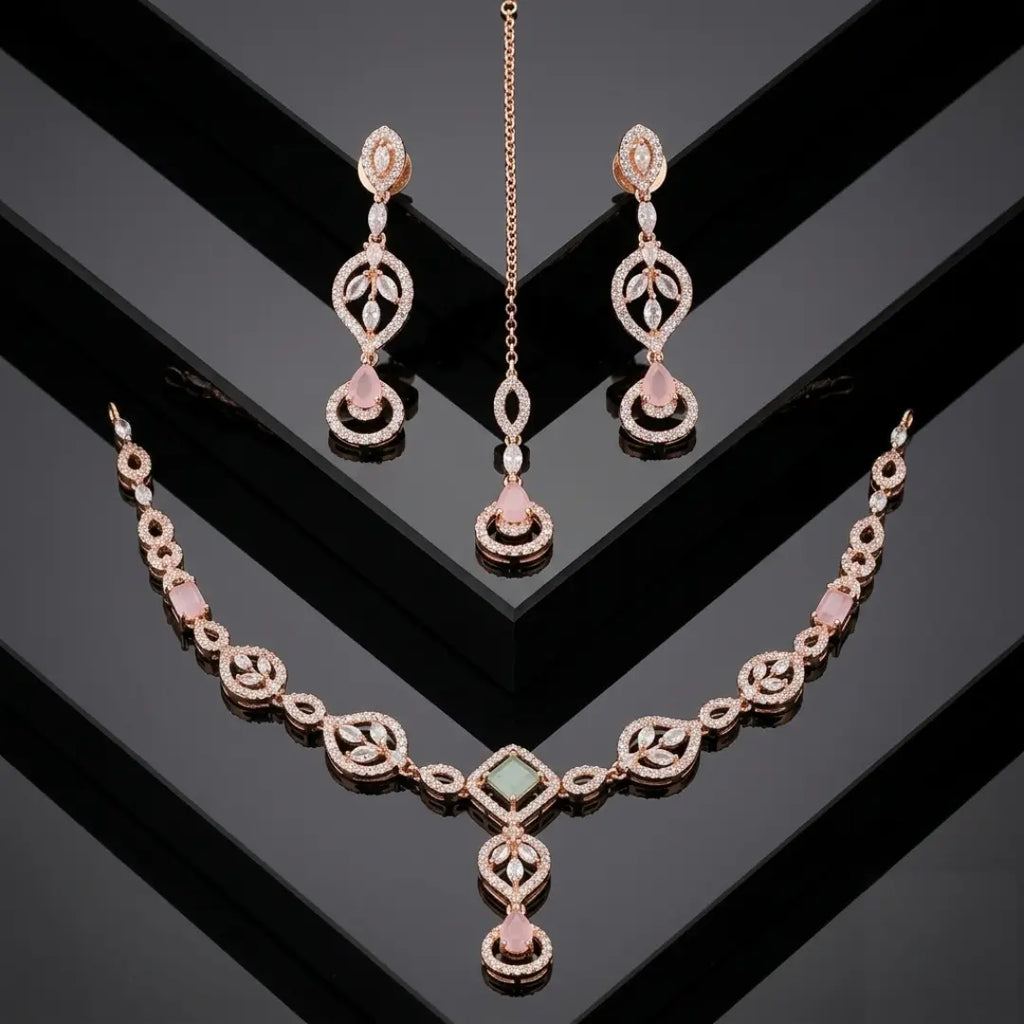 Rose Gold necklace set with pink stones and maang tikka on a black geometric background