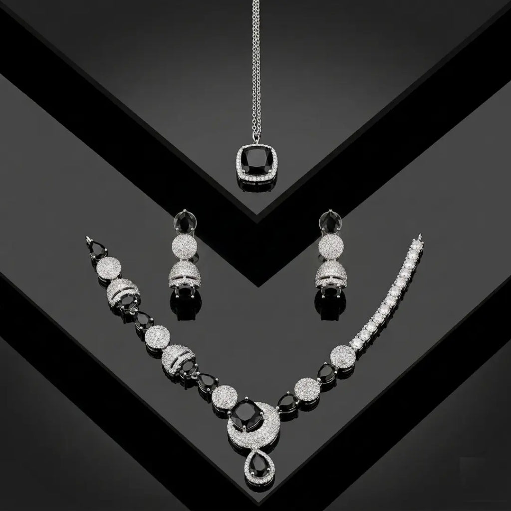 Luxury black and silver zirconia necklace set with earrings and pendant on a black geometric background.