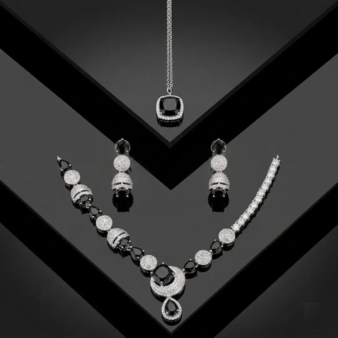 Luxury black and silver zirconia necklace set with earrings and pendant on a black geometric background.