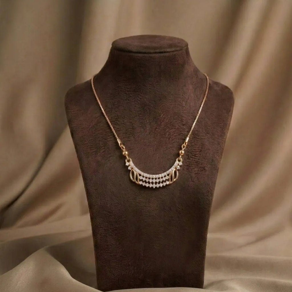Gold necklace with pearls on a brown mannequin bust against a brown fabric background
