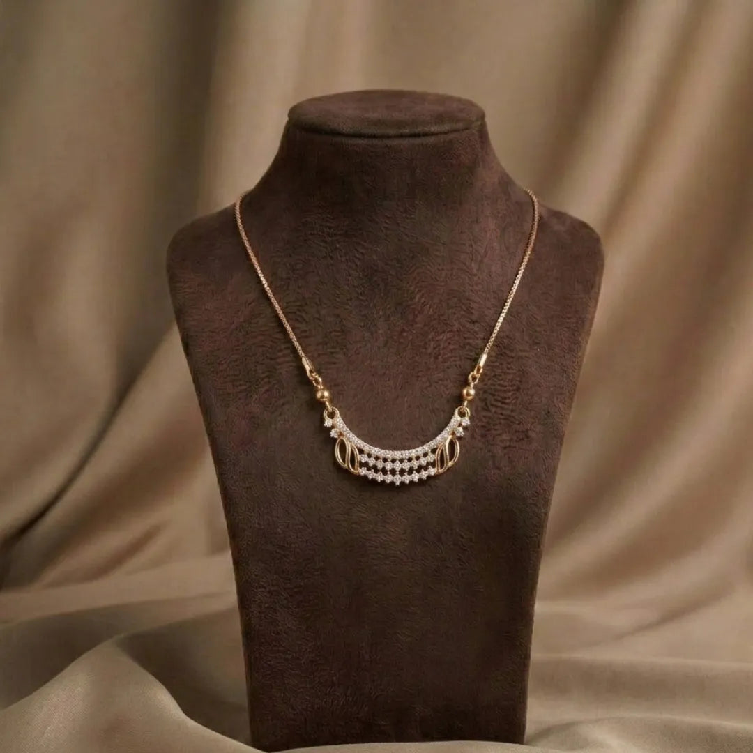 Gold necklace with pearls on a brown mannequin bust against a brown fabric background