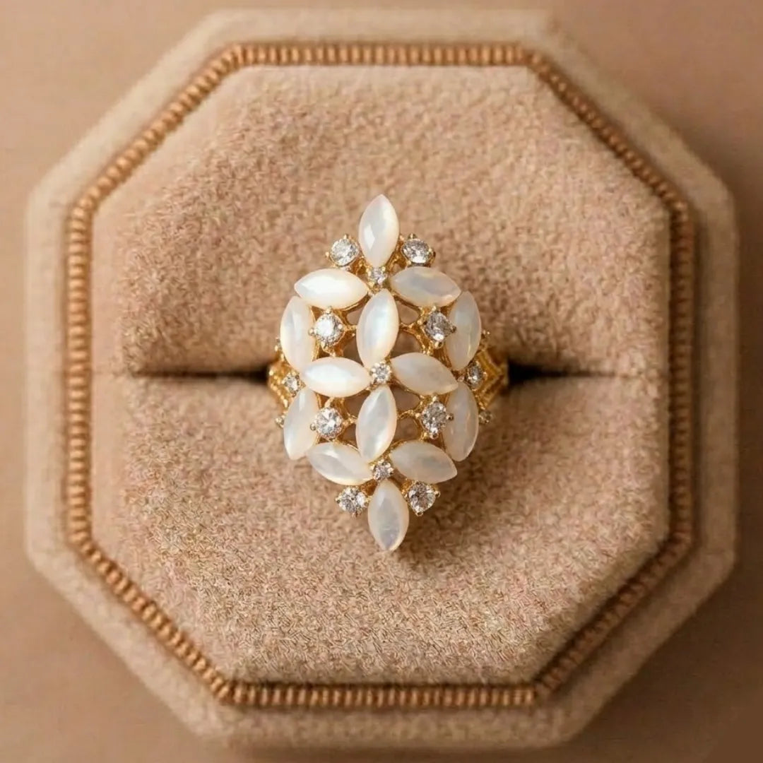Decorative ring with white stones on a beige cushioned stand