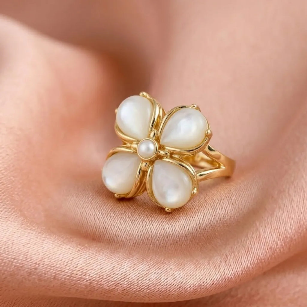 Gold ring with pearl-like stones on a skin background