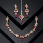 Multi-color Navratna style necklace and earrings set with rose-gold finish on a mannequin.